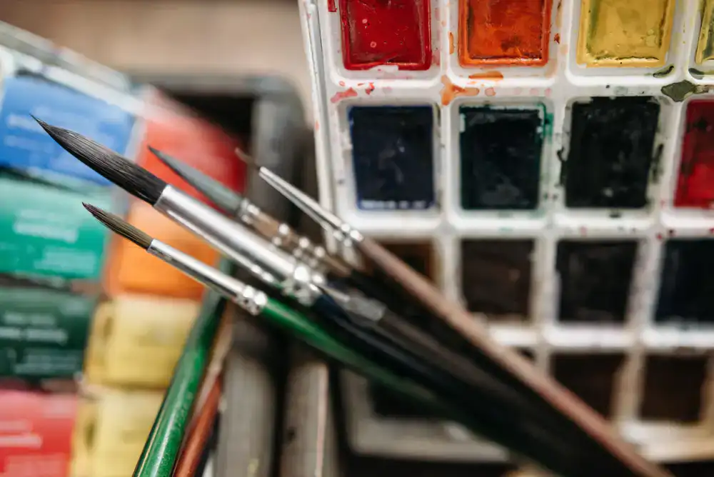 Detailed view of watercolour palettes and fine brushes